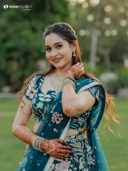 This bride looks absolutely radiant and confident during her Sangeet ceremony. Her elegant teal lehenga and happy expression make for a perfect portrait.
