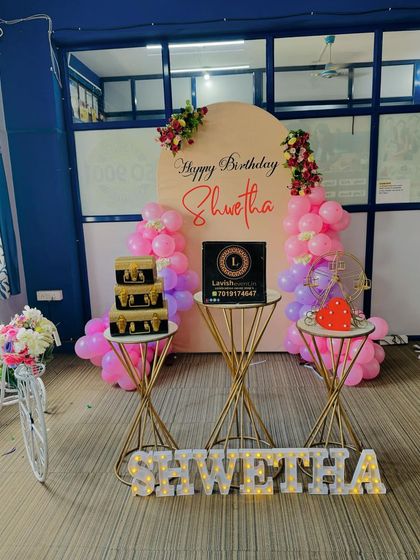 A slightly different angle of the same elegant birthday setup, showing the placement of the decorative gift boxes and props.