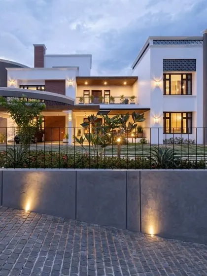 This single-story elevation proves that great design isn't about size, but about proportion and detail. The curved entry canopy and mix of materials give this modern home a unique and inviting character.