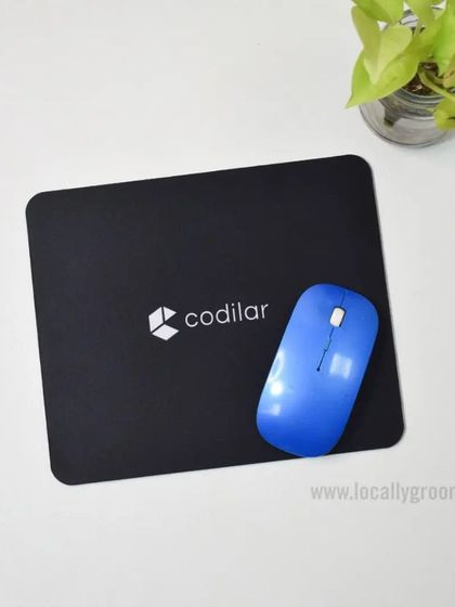 A custom-branded mousepad is a practical gift that guarantees daily visibility. Here is a sleek black mousepad we created for Codilar, paired with a wireless mouse.