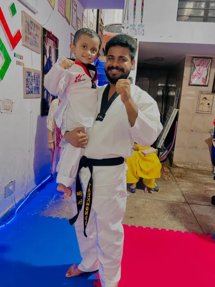 Holding up a future champion. These moments of connection and encouragement are just as important as the physical training in our academy.