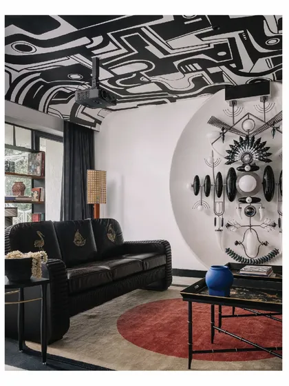 For us, art is never an afterthought; it is the soul of the room. In this media room from our 'Aria' project, the ceiling becomes a canvas for a hand-painted mural, inviting you to get lost in its whimsical narrative. The space is built around this art and a majestic totem light installation, creating a room meant for pausing, reflecting, and dreaming.