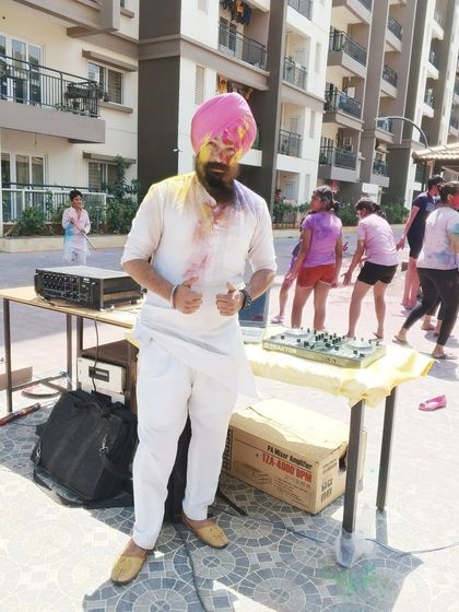 A photo from a Holi party, dressed in a traditional white kurta that's perfect for celebrating the festival of colors. Ready for the music and the mess!