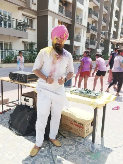 A photo from a Holi party, dressed in a traditional white kurta that's perfect for celebrating the festival of colors. Ready for the music and the mess!