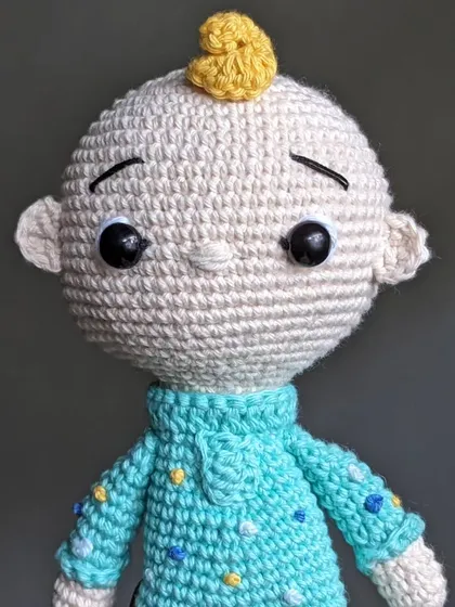 A detailed portrait of the JJ doll's face.