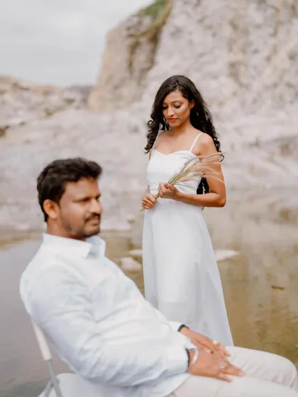A moody and atmospheric portrait from a pre-wedding shoot at a quarry. The composition creates a sense of quiet contemplation between the couple.