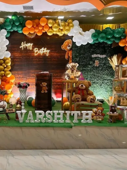 A full view of the teddy bear party, showing the marquee letters spelling out the name and the artfully arranged props, including transparent "BABY" blocks.