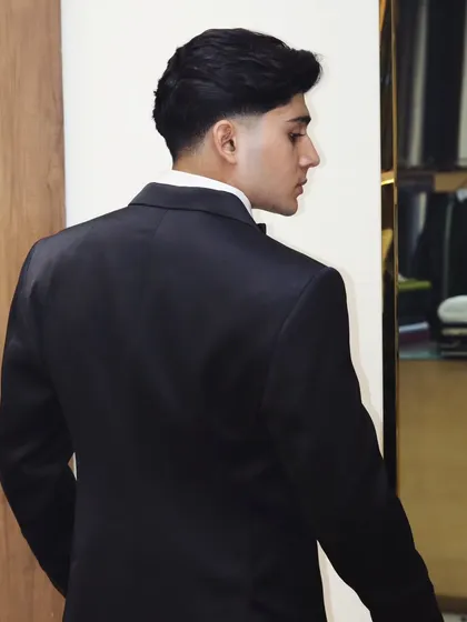 A clean, classic black suit is a must have. The fit across the back and shoulders is what separates a custom tailored suit from an off the rack one.