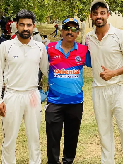 Teammates and a senior club member posing for a photo after a successful match. We are a close-knit community, from our youngest players to our most experienced mentors.
