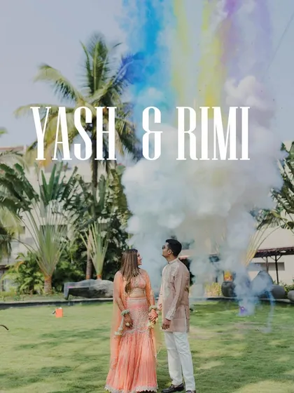 A burst of rainbow smoke marks the beginning of their Haldi celebration. This shot captures the vibrant, festive atmosphere and the couple's excitement.