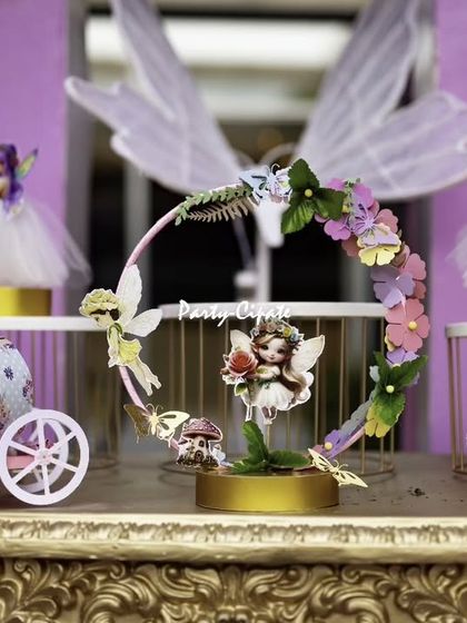 These intricate fairy-themed centerpieces, featuring miniature fairy dolls and carriages, added a touch of delicate magic to each table.