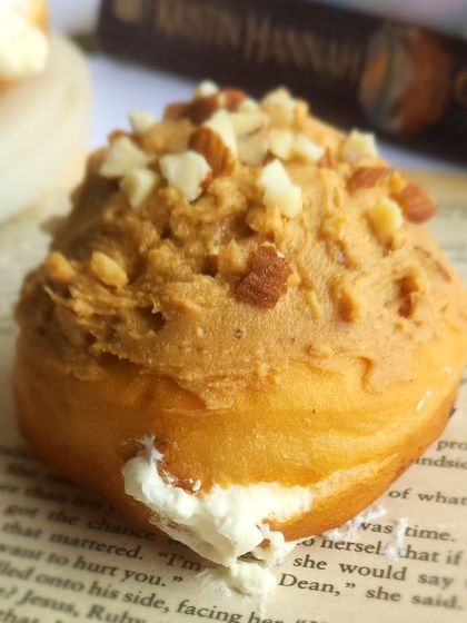 For peanut butter lovers, we have this cream filled berliner. The fluffy donut is filled with a light peanut butter cream and topped with a peanut crumble.