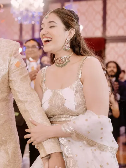 A candid laugh on the dance floor. This is what it's all about: creating a look that lets you enjoy your celebration to the fullest.