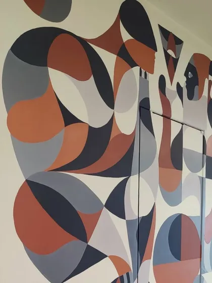 A detail of the geometric mural, showing the interplay of shapes and colors.
