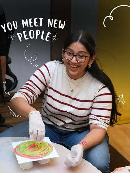 A participant smiles as she works on a fluid art piece. My studio is a place where you can meet new people and connect through a shared love for creativity.
