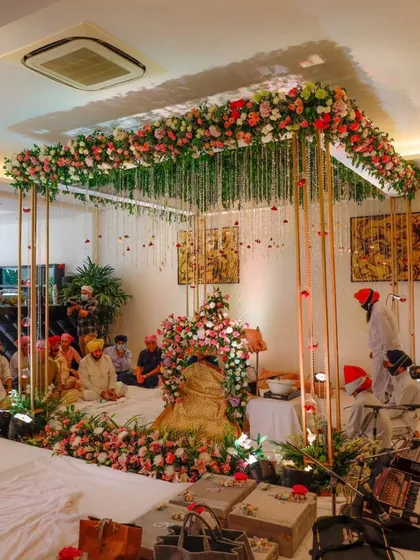A serene and beautiful setup for a Sukhmani Sahib Path at home. I used a floral canopy with hanging strings of flowers over the main seating area to create a divine atmosphere, perfect for spiritual gatherings and blessings.