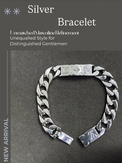 A unisex silver bracelet with a heavy curb chain design. The central plaque features a subtle, stylish engraving.