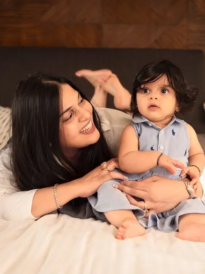 A mother and her baby share a smile during their cozy at-home lifestyle shoot. These sessions are all about capturing your real life in a beautiful way.