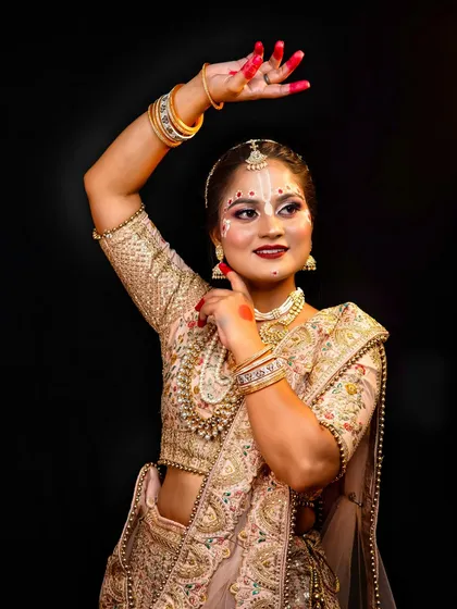 A beautiful Radha-inspired look, featuring traditional tilak and alta on the hands. This is a perfect example of festive makeup artistry.