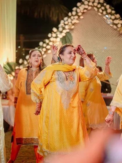 The ladies in yellow, bringing sunshine to the mehendi ceremony with their dance.
