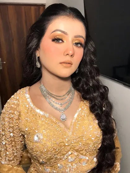 A final portrait of the bride, her diamond jewelry the perfect choice for her golden engagement outfit.