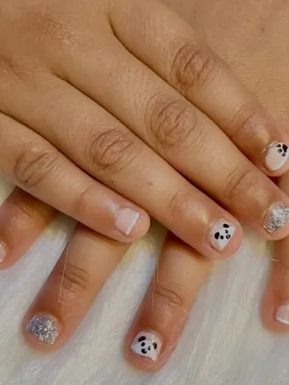 A perfect example of how I can create magic even on bitten nails. This super cute set features tiny, hand-painted pandas and silver glitter accent nails.