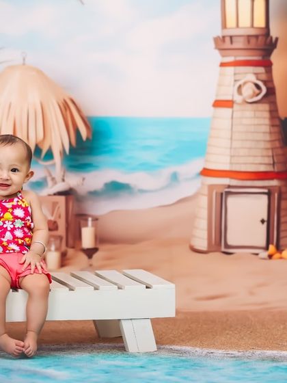 A day at the beach, right in my studio. This baby girl is enjoying her beach-themed session, complete with a lounge chair, a beach backdrop, and a refreshing drink prop.