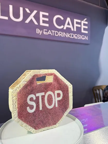 A savory pastry designed to look like a stop sign, created for our pop-up café. This is an example of our quirky and graphic approach to edible design.