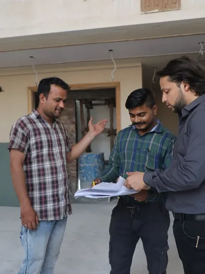 Our principal architect on-site, reviewing plans with the construction team. We maintain a hands-on approach throughout the entire process to ensure quality and precision.
