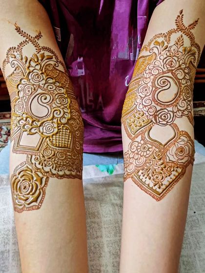 A unique design on the elbows, featuring paisleys and florals. I ensure every part of the arm is beautifully decorated.