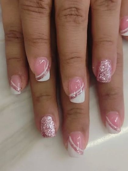 A modern and graphic take on the French manicure. I used a pink base with a white tip, separated by a diagonal silver glitter line for a sharp look.