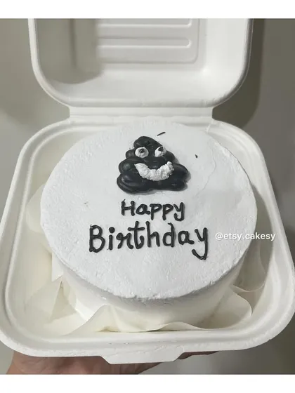 A humorous birthday bento cake with a cartoon poop emoji, perfect for a friend with a great sense of humor.