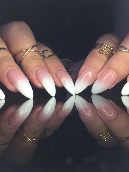 A classic baby boomer ombre on long, sharp stiletto nails, combining elegance with an edgy shape.