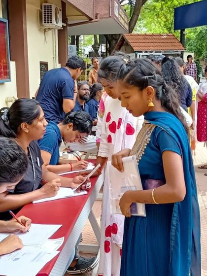 Volunteers at the registration desk, diligently helping candidates fill out forms and guiding them at the inclusive job fair.