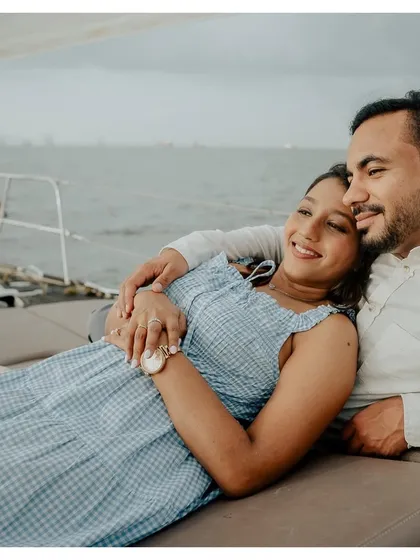 A tender moment of rest during a pre-wedding yacht shoot, showing the couple's comfortable and easy love.