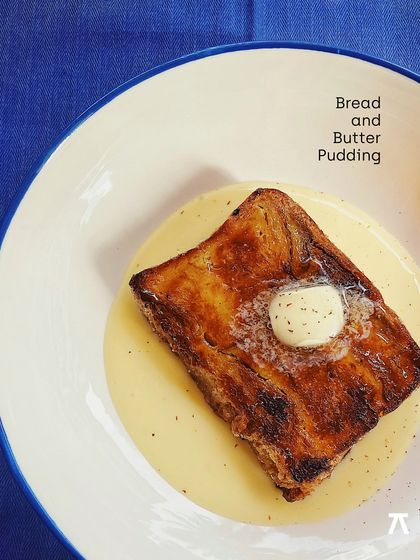 The classic Bread and Butter Pudding from the Padaria Prazeres brunch, a comforting dish of brioche pudding and crème anglaise.
