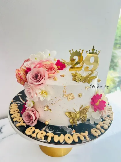 Elegance in every bite. A stunning cake with pink flowers and golden butterflies for a 29th birthday.
