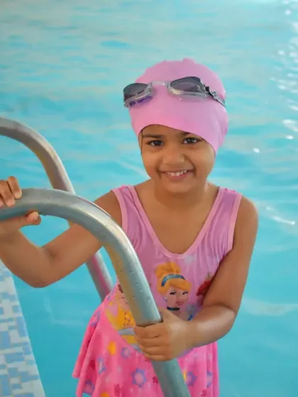 Look at that smile. My goal is to make every child feel confident and happy in the water. This is what successful first swimming lessons look like.