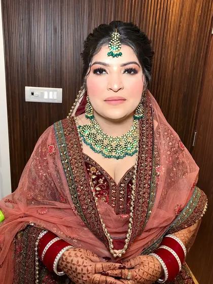 A serene portrait of the bride, with her hands clasped, showing off her mehndi and rings.