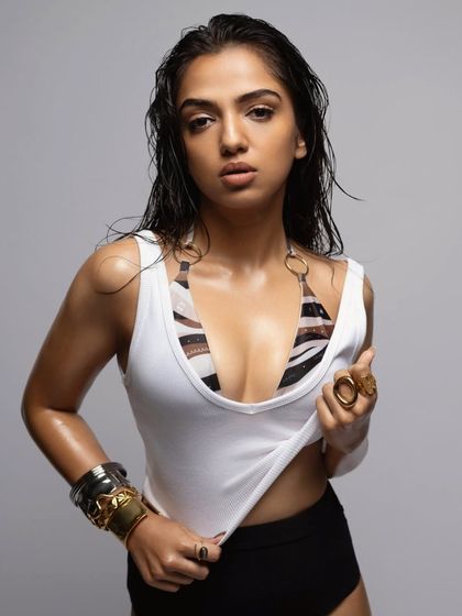 We switched things up with a wet hair look and layered jewelry for Ahsaas Channa. This styling, with a simple white tank over a bikini top and bold cuffs, creates a raw and edgy feel.
