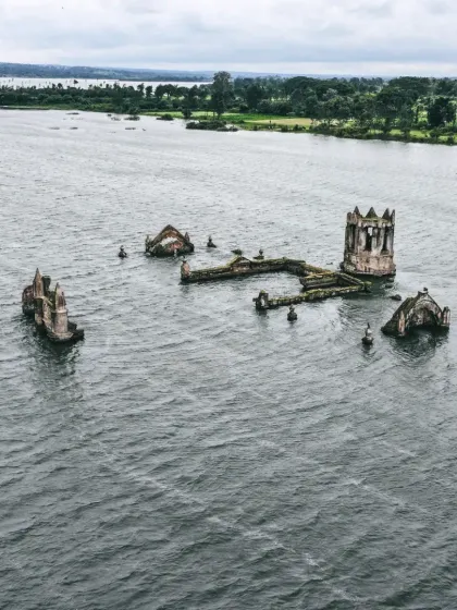 The Shettihalli Rosary Church, partially submerged in the Hemavathi backwaters during the monsoon, creating a hauntingly beautiful scene.