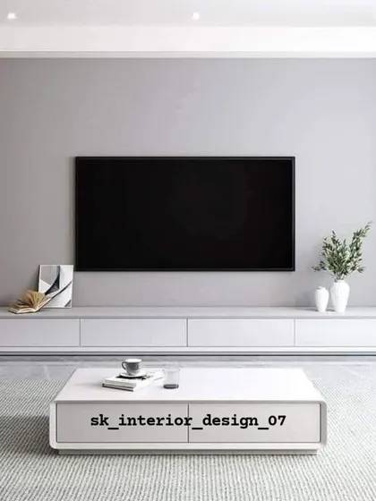 A minimalist TV setup with a low-profile white console and matching coffee table. This design emphasizes clean lines and is perfect for a modern, uncluttered aesthetic.