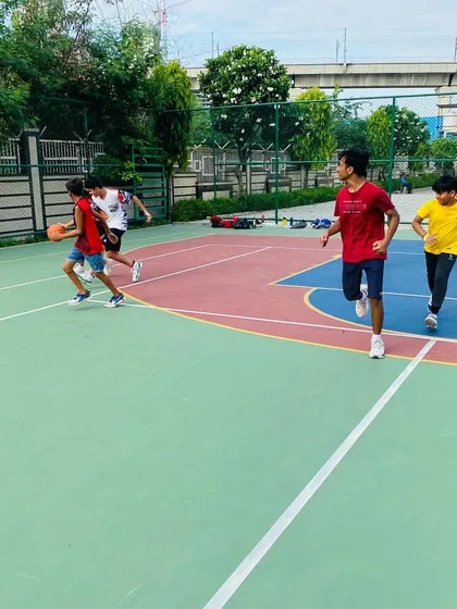 Players run a fast break drill, practicing passing and finishing in transition.