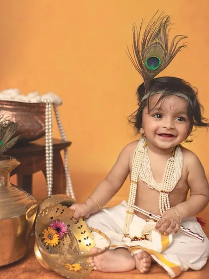 A billion-dollar smile. This happy little Krishna, with his peacock feather and pearl necklace, perfectly captures the joyful spirit of the theme.