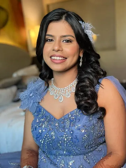 A glamorous cocktail party look. The makeup is bold and beautiful, with a focus on the eyes and a flawless base.