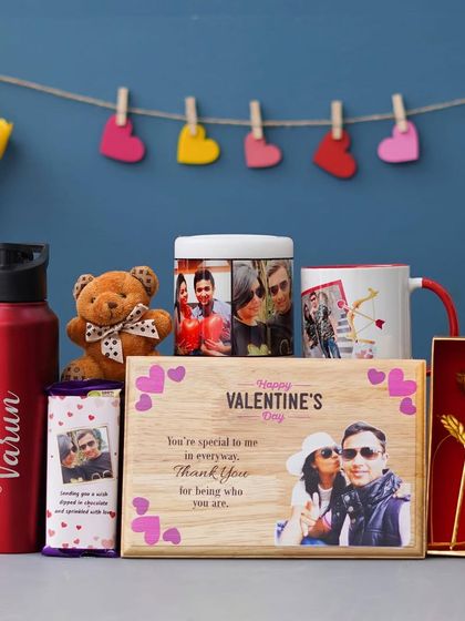 This all-in-one Valentine's combo is packed with love. It features a personalized wooden frame, a Bluetooth speaker with your photos, a custom mug, a name-engraved bottle, and other sweet treats.