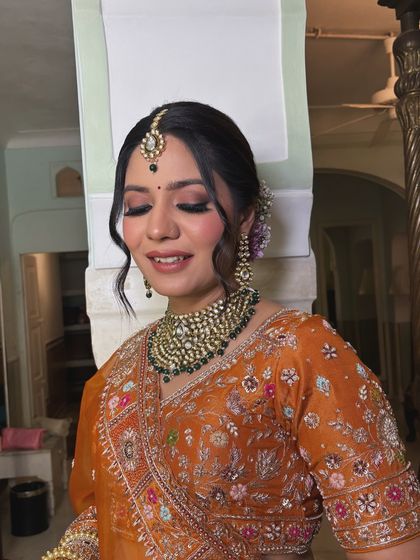 This bride's happy expression says it all. The elegant updo with flowers keeps her hair perfectly in place while looking absolutely beautiful from every angle.
