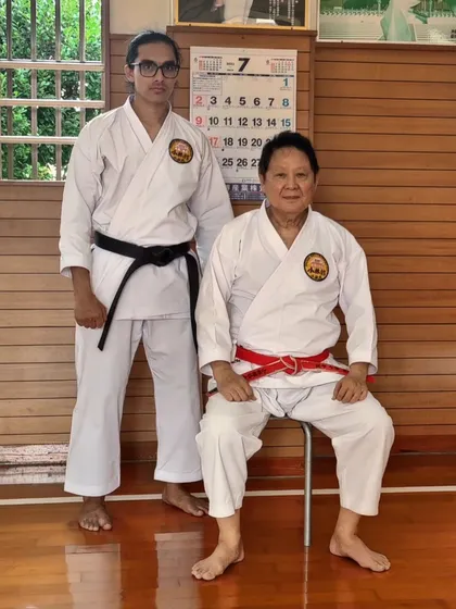 Posing with the grandmaster is a sign of respect and marks a student's progress on their journey.