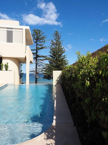The edge of the infinity pool blends seamlessly with the ocean horizon. We use minimalist planting and a glass fence to ensure the view remains completely unobstructed.