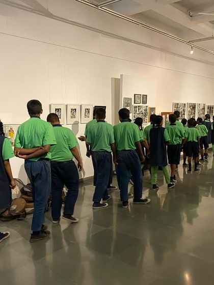 A view from the back of the student group as they walk through the gallery.